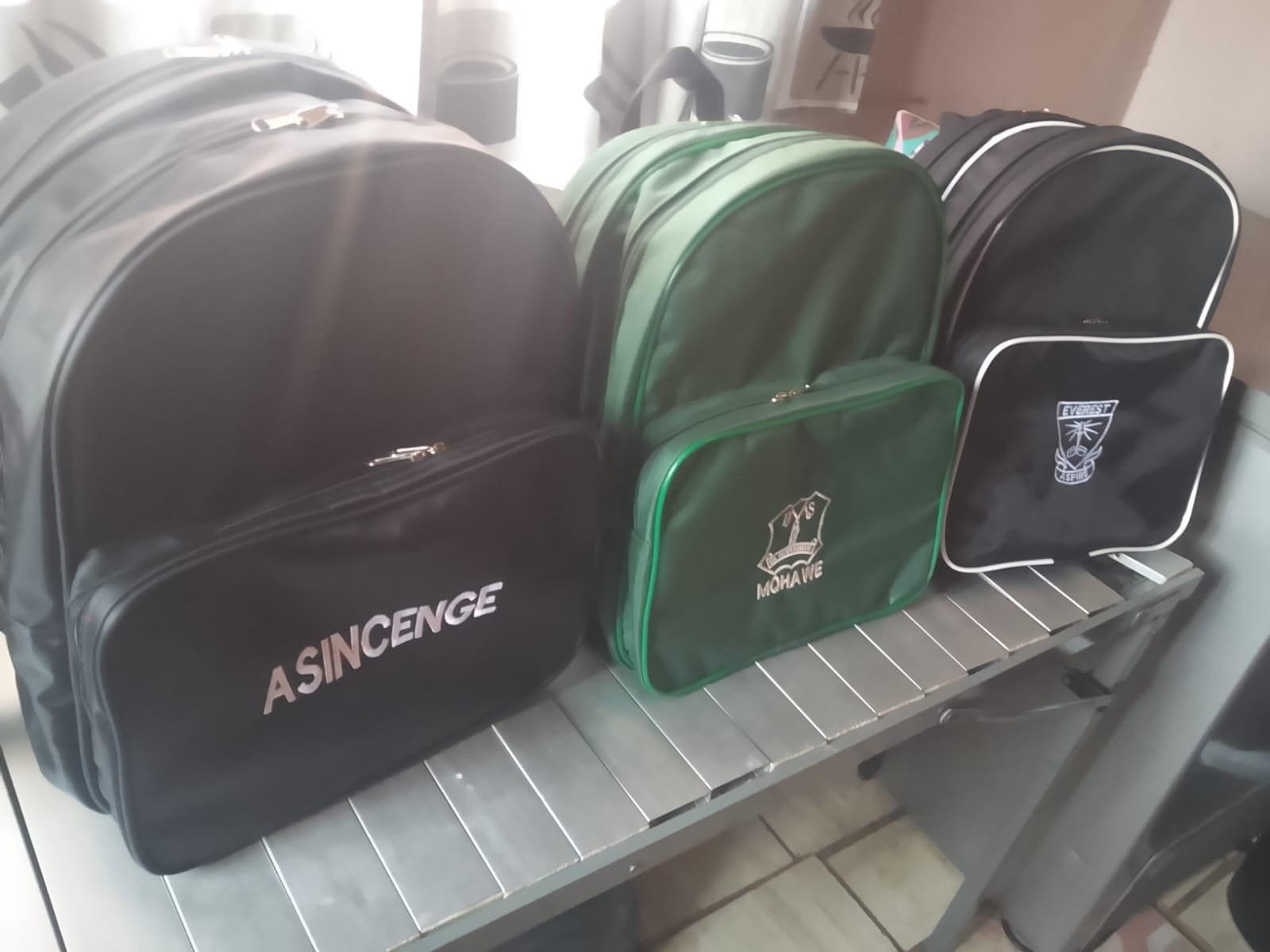 Green and black school beanie and bag